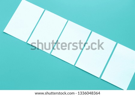Blank portrait mock-up paper. brochure magazine isolated on blue, changeable background / white paper isolated on light blue paper.