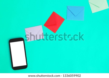 Smartphone with envelopes on blue background.