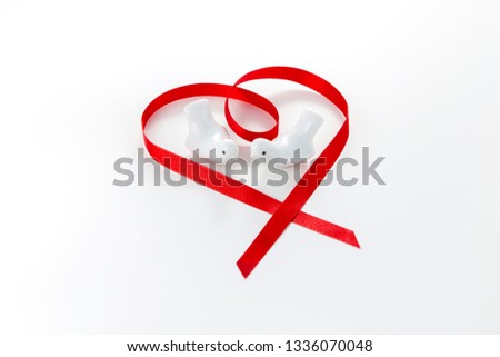 Ceramic white dove and heart shape of red ribbon