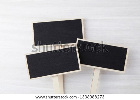 Blank various blackboard labels isolated on white wooden background