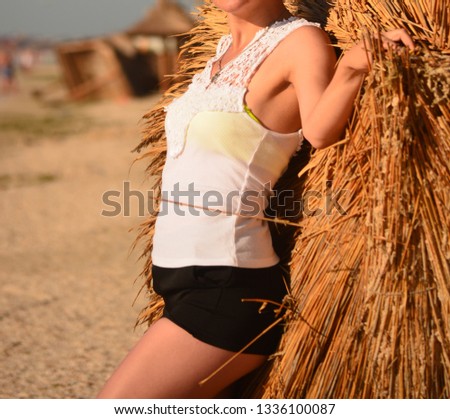 Young woman poses for a photographer at a photo shoot near the sea
