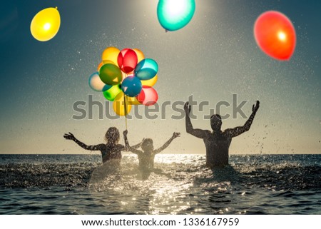 Happy family playing in the sea. Child, mother and father having fun on summer vacation. Healthy active lifestyle concept
