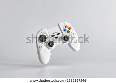 White gamepad on white uniform background. Minimalism. Copy space for text Royalty-Free Stock Photo #1336169546