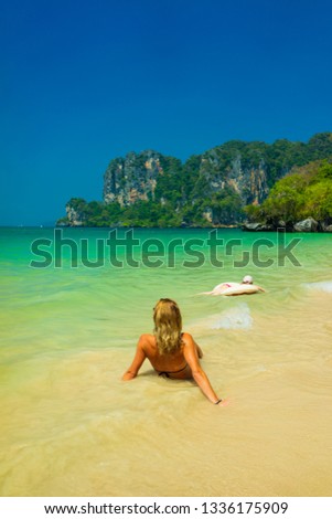 Cute woman relaxing on the summer tropical beach. winter vacation in Paradise.