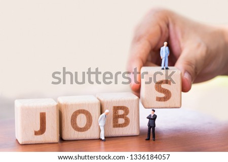 Wood block word JOB and magnifying glass with copy space using as background Choice of the best suited employee, HR, HRM, HRD, job recruiter concepts.