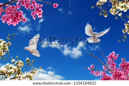 pink and white tree branches with blue doves in the blue sky