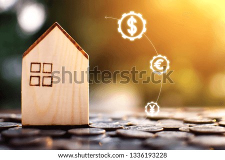 Little wood house model with coins saving for residential .