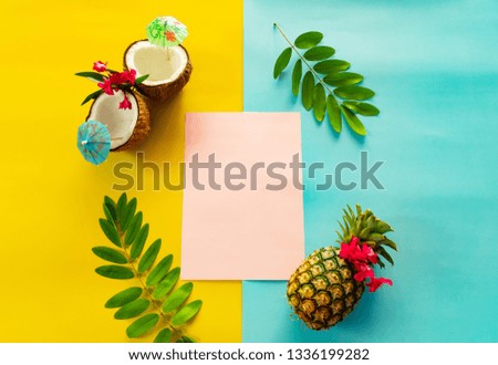 Summer holiday setting with coconuts, pineapple and green leaf on colorful background.top view and copy space for text.