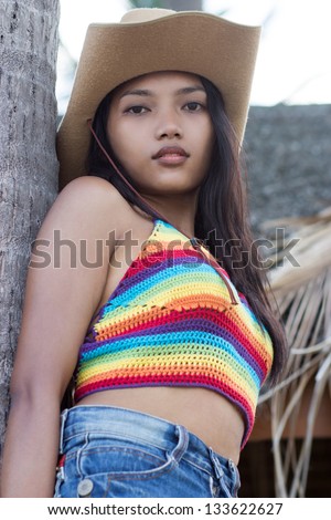 girl resting on a tree trunk