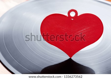 LP vinyl record with red heart. This is nostalgic love song, retro styled. Royalty-Free Stock Photo #1336273562
