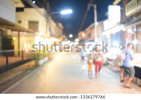 Light bokeh on walking street blurred people at midnight