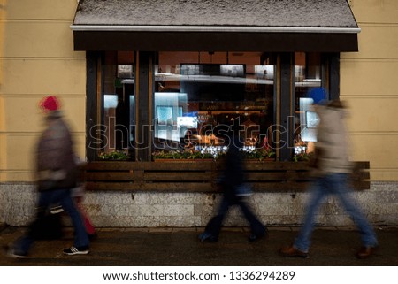 people passing by the Windows of the cafe