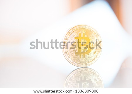Golden Bitcoin on light background. Close-up, macro shot. New Virtual Money 