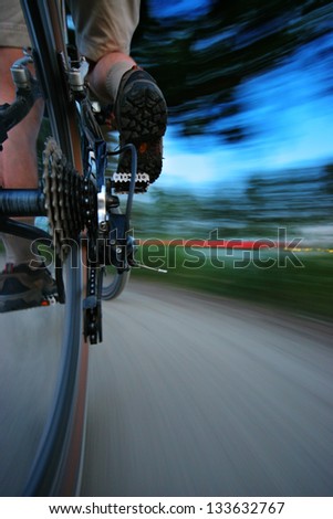 Speeding on the bike. Sharp derailleur and motion blurred background (panning effect)