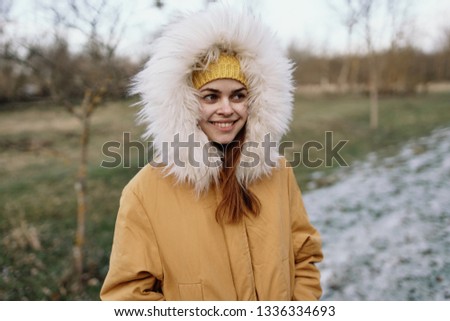  woman in the hood on nature is smiling                             