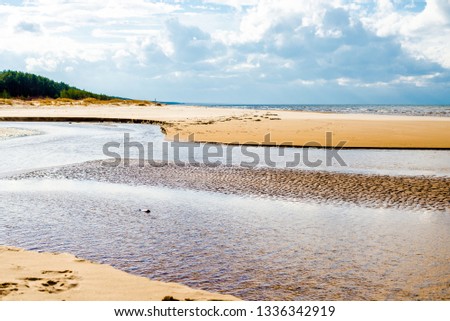 Spring landscape. View of the coast and the Baltic Sea on a clear sunny day. Clouds, waves and wind. Latvia