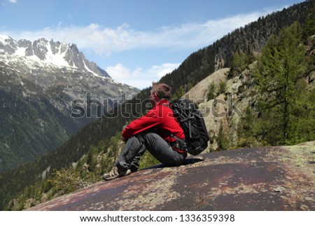 Tourist hiker enjoying view of mountains in French Alps