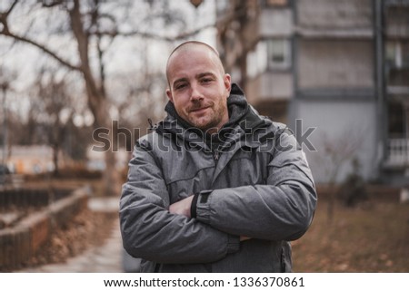 Portrait of ordinary bold young man in neighborhood Royalty-Free Stock Photo #1336370861