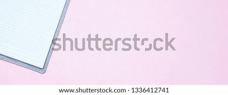 Single simple empty white notebook with a blank for drawing or writing, on pink background Top view. Mock up. Flat lay. long banner