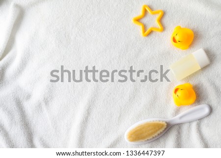 Flat lay beauty photo star, liquid soap bottle and yellow duck baby toy on a white background. Toiletries kit, beauty still life photography. Bath products items. Mockup.child flat lay