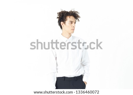 Cute curly guy in a white shirt on a light background office worker