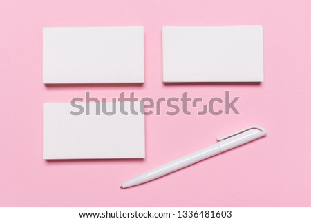 Blank white business cards on pink background. Mockup for branding identity. Template for graphic designers portfolios. Top view. 