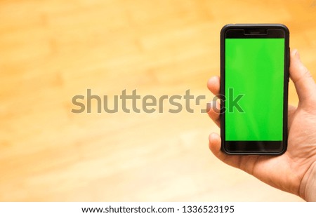 Male hand with Smartphone. Chroma key. Place for your advertisement.