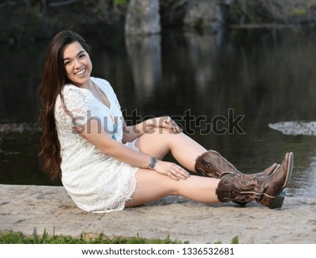 Young High School Senior posing for graduation pictures