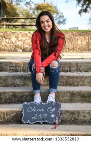 Young High School Senior posing for graduation pictures