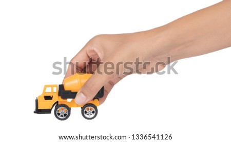 Hand holding toy truck concrete mixer isolated on white background