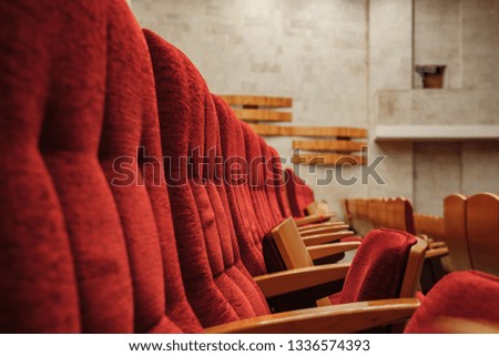 red chairs in the auditorium at the concert, close up