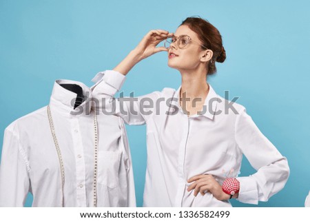 female fashion designer leaning on a mannequin atelier sewing