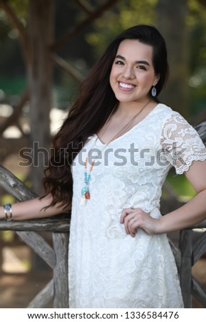 Young high school girl posing for graduation pictures