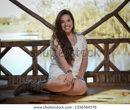 Young high school girl posing for graduation pictures