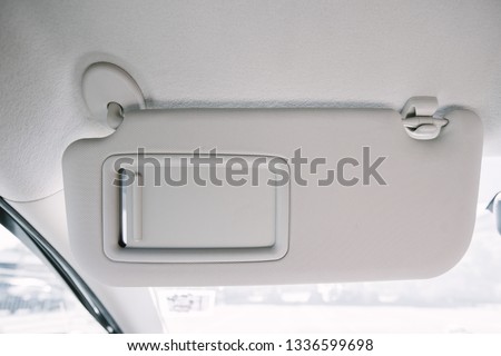 Sun visor with mirror in a car. Royalty-Free Stock Photo #1336599698