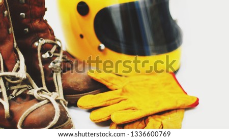 Brown leather men old yellow motorcycle helmet. Leather gloves yellow on a white background.