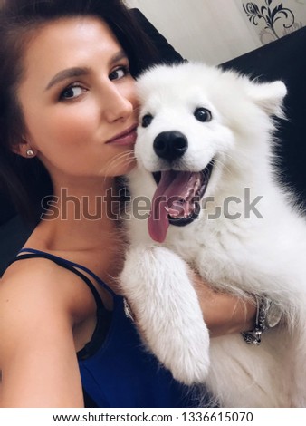 a happy samoyed dog with a girl