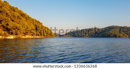 Beautiful sunset on lake Jezero in the national park of Mljet in Croatia, small island with the Benedictine Monastery on the water, perfect place to visit during a sailing tour on the sea