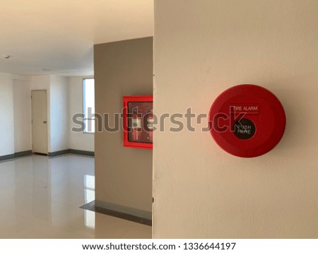 Fire alarm button hanging on the wall for safety