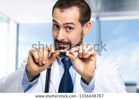 Doctor breaking a cigarette