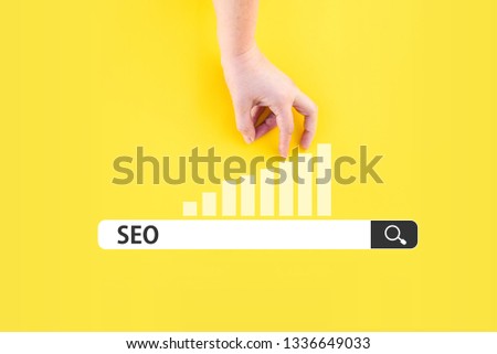 search bar with SEO word and hand on chart. seo optimization concept
