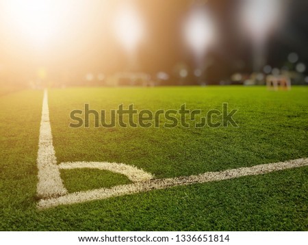 Football field Corner kick position with warm lights.