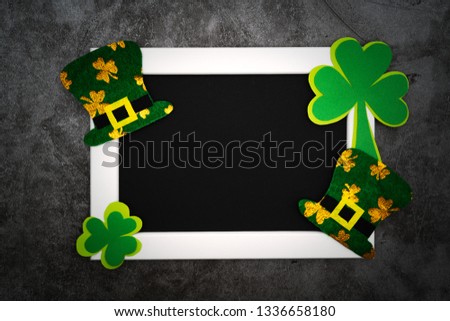 St Patricks day, festive leprechaun hat and green Shamrocks on photo frame