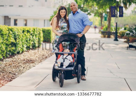 mom and dad a wonderful little son walking in summer sunny city