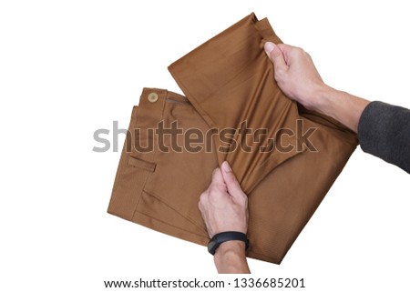 Chino pants spandex brown color stretch by men hand. Royalty-Free Stock Photo #1336685201