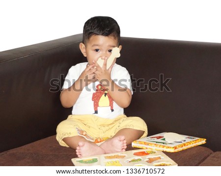 Asian boy sit and play a toy at home