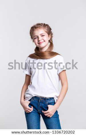 Wearing ordinary outfit. Pleasant pretty girl with healthy long hair being happy while posing for camera and smiling