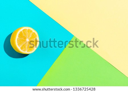 Top view of fresh lemon isolated on multicolored background. Fruit minimal concept.