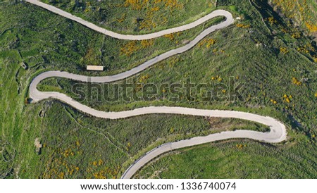 Aerial drone top view photo of serpentine snake curve road in green mountain with beautiful nature