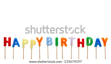 Colorful candles in letters saying Happy Birthday, isolated on white background